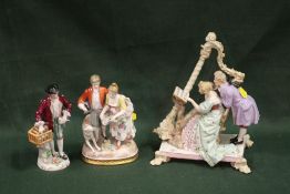 A CONTINENTAL STYLE FIGURE OF A LADY AND GENTLEMAN PLAYING A HARP, TOGETHER WITH TWO OTHER