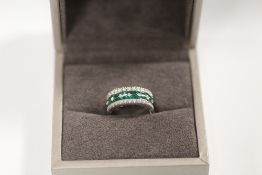 A WHITE GOLD EMERALD AND DIAMOND RING, set with an estimated 1.20 carats of emeralds and twenty