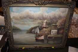 A GILT FRAMED OIL ON CANVAS OF A WINDMILL BY A RIVER SIGNED JT CARTER