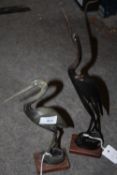 A PAIR OF BUFFALO HORN STORK FIGURES