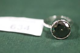 A STERLING SILVER AND BLUE MOISSANITE DRESS RING