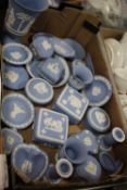 A TRAY OF BLUE WEDGWOOD JASPERWARE TO INCLUDE TRINKET POTS, CANDLESTICKS ETC.