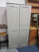 A PAINTED SCHOOL TYPE TWO DOOR CUPBOARD H-191 W-92 CM