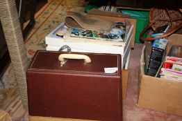 A CASED SINGER SEWING MACHINE TOGETHER WITH TWO BOXES OF ACCESSORIES ETC.
