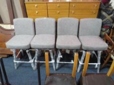 A SET OF FOUR MODERN UPHOLSTERED SWIVEL BAR STOOLS