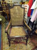A LARGE OAK FRAMED BERGERE ARMCHAIR