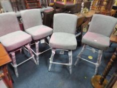 A SET OF FOUR MODERN UPHOLSTERED SWIVEL BAR STOOLS