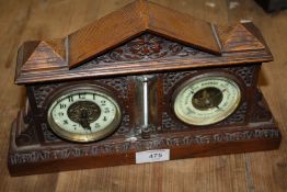 AN ANTIQUE CARVED OAK CASED COMBINATION DESKTOP CLOCK AND BAROMETER