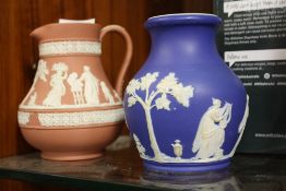 A TERRACOTTA WEDGWOOD JASPERWARE JUG, TOGETHER WITH A BLUE DIP JASPERWARE VASE (2)
