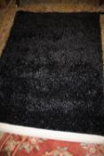 A MODERN INDIAN BLACK RUG 120 X 180 CM