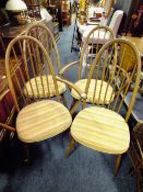 A SET OF FOUR ERCOL HOOP BACK DINING CHAIRS INCLUDING TWO ARMCHAIRS (4)
