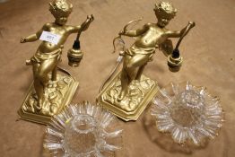 A PAIR OF GILDED CAST METAL CHERUBIC WALL LIGHTS WITH GLASS SHADES