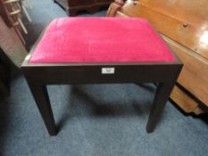 A MODERN BLACK AND PINK UPHOLSTERED STOOL