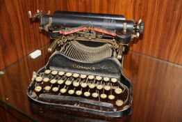 AN ANTIQUE CORONA FOLDING TYPEWRITER