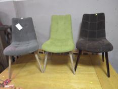 A SET OF THREE HARLEQUIN UPHOLSTERED DINING CHAIRS