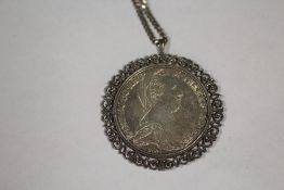 A COIN PENDANT ON SILVER CHAIN
