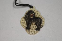 A CARVED AND PIERCED VICTORIAN TYPE IVORY PENDANT DECORATED WITH A LION, H 5.5 cm A/FCondition