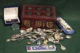 A LEATHER COATED LIDDED BOX CONTAINING SOUVENIR SPOONS, COALPORT HAT PIN ETC.