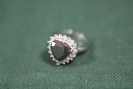 A STERLING SILVER AND MODERN BLACK DIAMOND STYLE DRESS RING