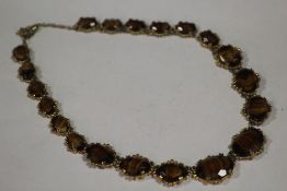 A VINTAGE TIGERS EYE STYLE AGATE NECKLACE, in a gilt mount