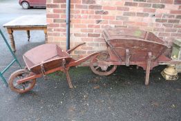 TWO VINTAGE WOODEN WHEELBARROWS