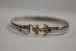 A WHITE AND YELLOW METAL BANGLE STAMPED STERLING 14K WITH ANCHOR SHAPED CLASP APPROX WEIGHT - 15.3G