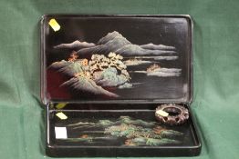 TWO ORIENTAL LAQUERWARE TRAYS, TOGETHER WITH A WOODEN PLINTH (3)