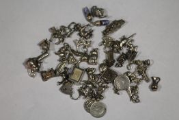 A LARGE QUANTITY OF SILVER BRACELET CHARMS APPROX WEIGHT 100G