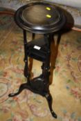 A MODERN EBONISED TORCHERE