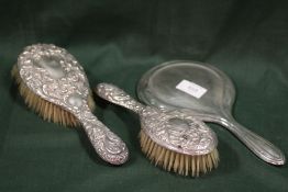 TWO HALLMARKED SILVER BRUSHES TOGETHER WITH A HALLMARKED SILVER HAND MIRROR (3)
