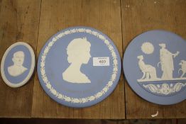TWO LARGE WEDGWOOD JASPERWARE CIRCULAR PLAQUES, TOGETHER WITH A SMALLER OVAL SHAPED EXAMPLE (3)