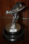 A VINTAGE CHROMED STATUETTE / CAR MASCOT OF 'THE SPIRIT OF ECSTASY', raised on a circular base,