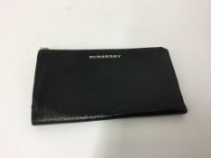 BURBERRY - a black shiny zip up purse