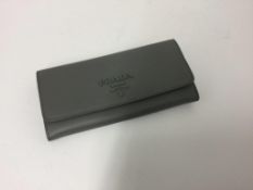 PRADA - a grey zip up purse (worn slightly)