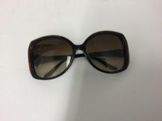 MICHAEL KORS - a pair of black and brown sunglasses