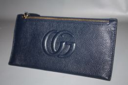 GUCCI - a ladies blue zippered top leather wallet
