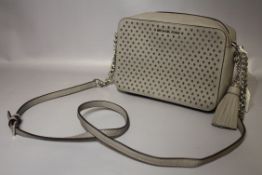 MICHAEL KORS - Grey small shoulder / cross body bag with cut out star design to front panel