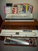 A BROTHER KNITTING MACHINE AND ACCESSORIES WITH AN ENCLOSED UNIT AND VARIOUS KNITTING PATTERNS