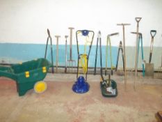 A QUANTITY OF GARDEN TOOLS INCLUDING A MOWER AND A WHEELBARROW