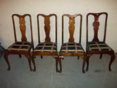 A SET OF FOUR ANTIQUE DINING CHAIRS WITH CABRIOLE LEGS