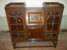 AN OAK ANTIQUE BUREAU DISPLAY CABINET WITH LEATHER INLAY