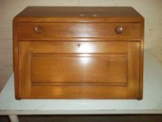 A BLONDE TABLE TOP FOLD DOWN DESK IN THE STYLE OF ERCOL