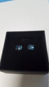 A PAIR OF LONDON BLUE TOPAZ STUDS, BOXED