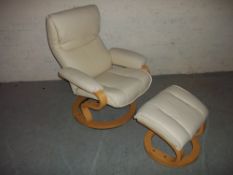 A FAUX LEATHER SWIVEL RECLINER CHAIR AND FOOT STOOL