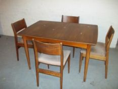 A VINTAGE TEAK EXTENDING DINING TABLE WITH FOUR CHAIRS
