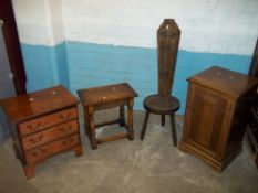 AN OAK LINENFOLD BEDSIDE CUPBOARD, AN OAK STOOL, A THREE DRAWER CHEST AND A HALL CHAIR (4)