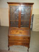 AN ANTIQUE LEATHER INLAID BUREAU BOOKCASE WITH BALL & CLAW FEET