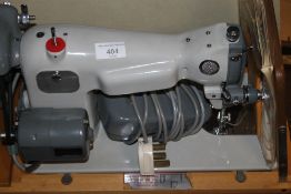 A CASED SEWING MACHINE