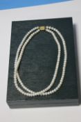 A TWO STRAND ERNEST JONES PEARL NECKLACE WITH A 9 CT GOLD CLASP