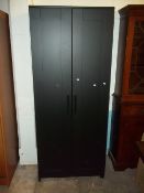 AN IKEA TWO DOOR WARDROBE IN BLACK